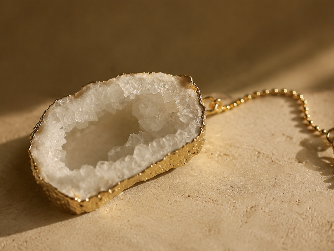 Druzy crystal pendant with gold edge on a Rocking Vibe necklace, representing lasting materials